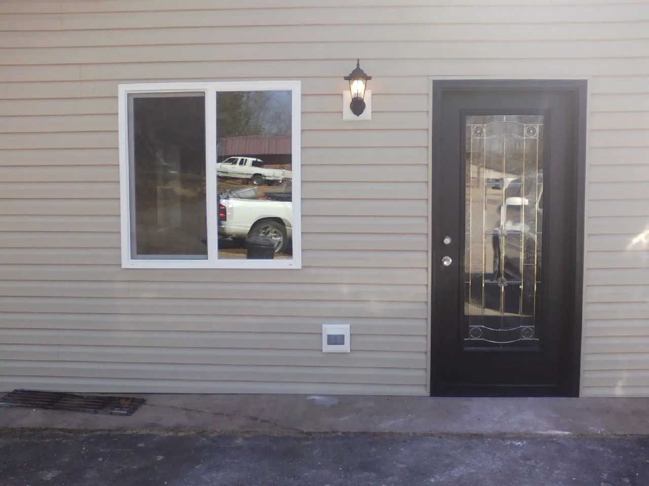 New siding, window and entry door on the side of an addition in Hickory